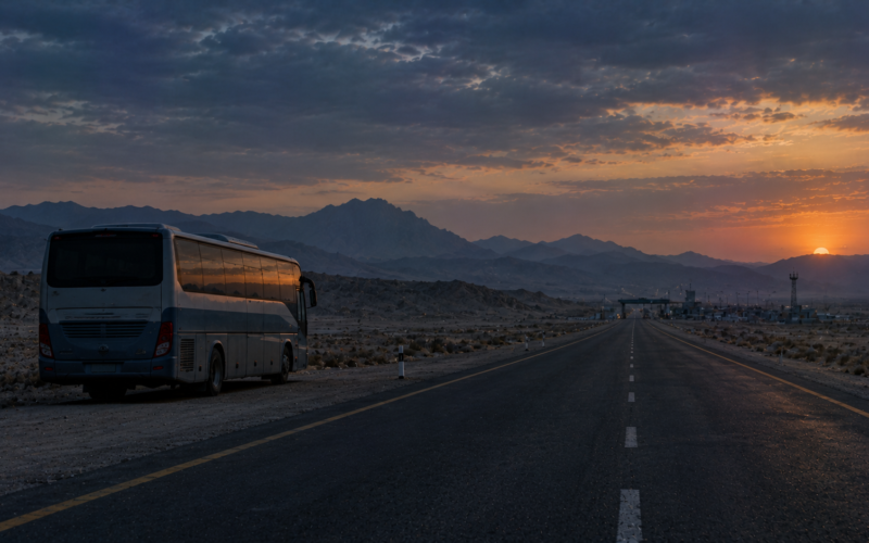 Parked passenger van on an empty mountain highway at dusk